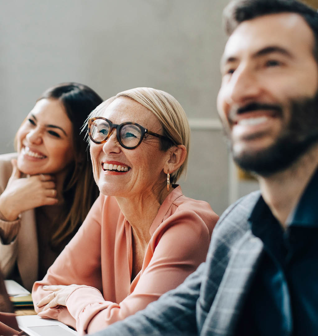Group of smiling co-workers looking off to left