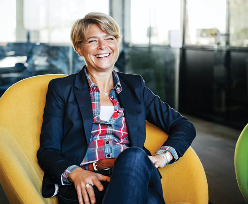 Woman in corporate office sitting and smiling